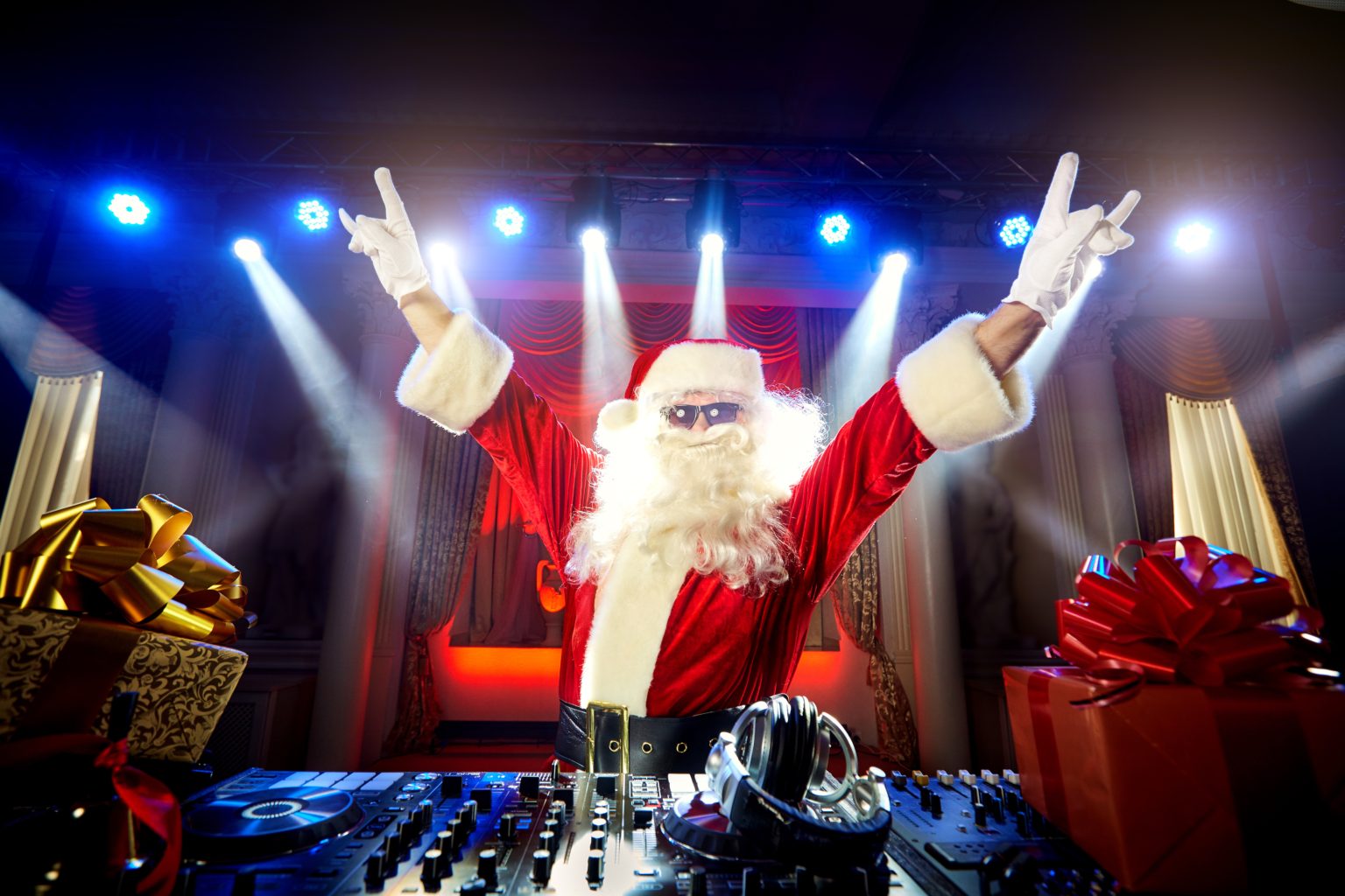 DJ Santa Claus mixing up some Christmas event. Disco light arou